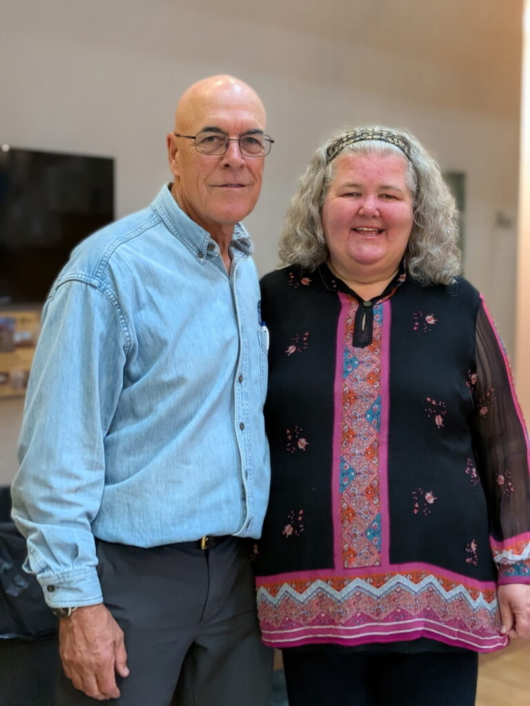 Two smiling individuals at Macon Sense event, celebrating innovation.