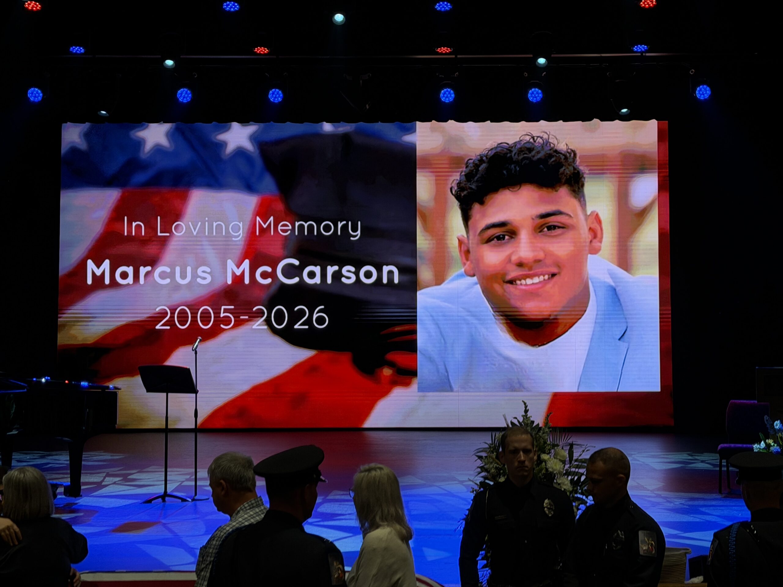 Memorial tribute for Marcus McCarson with American flag background and photo.