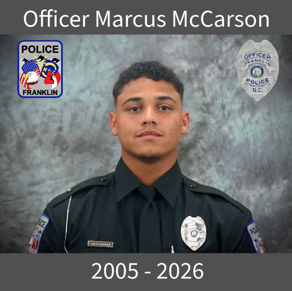 Memorial photo of Officer Marcus McCarson in uniform with police badges.