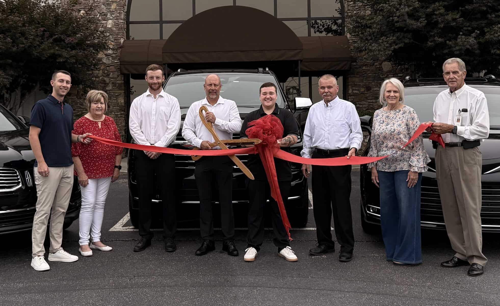 Group of people at ribbon-cutting ceremony for Summit Reserve Black Car Service.