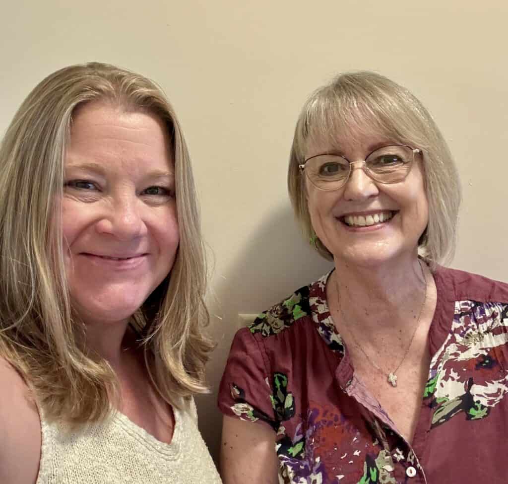 Two smiling women posing for a photo indoors at Macon Sense.