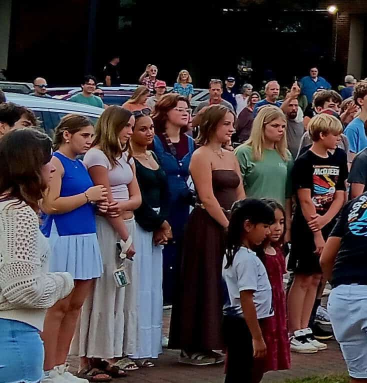 Community gathering at Gazebo for worship during church event.