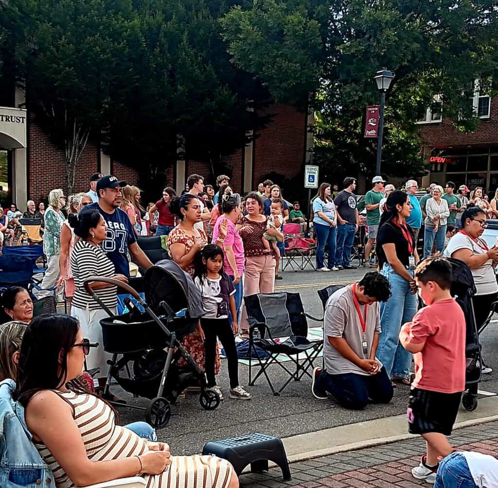 Community gathering at Gazebo for worship during church event.