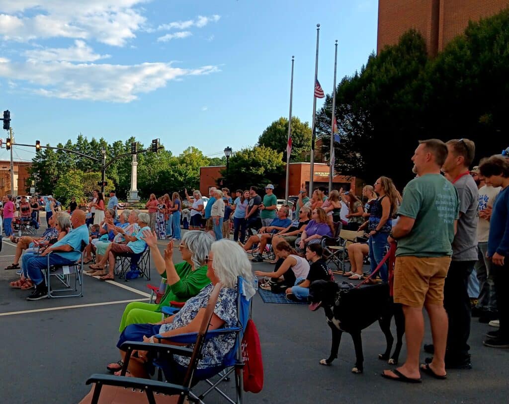 Community gathering at Gazebo for worship during church event.