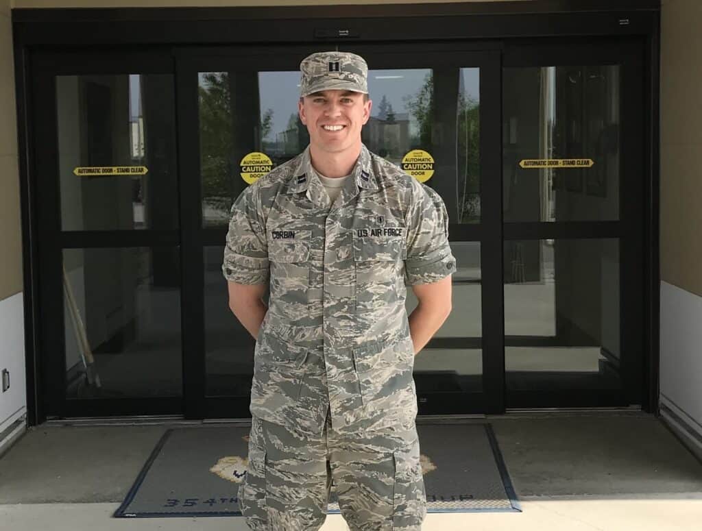 Young male Air Force member in uniform standing outside a building.