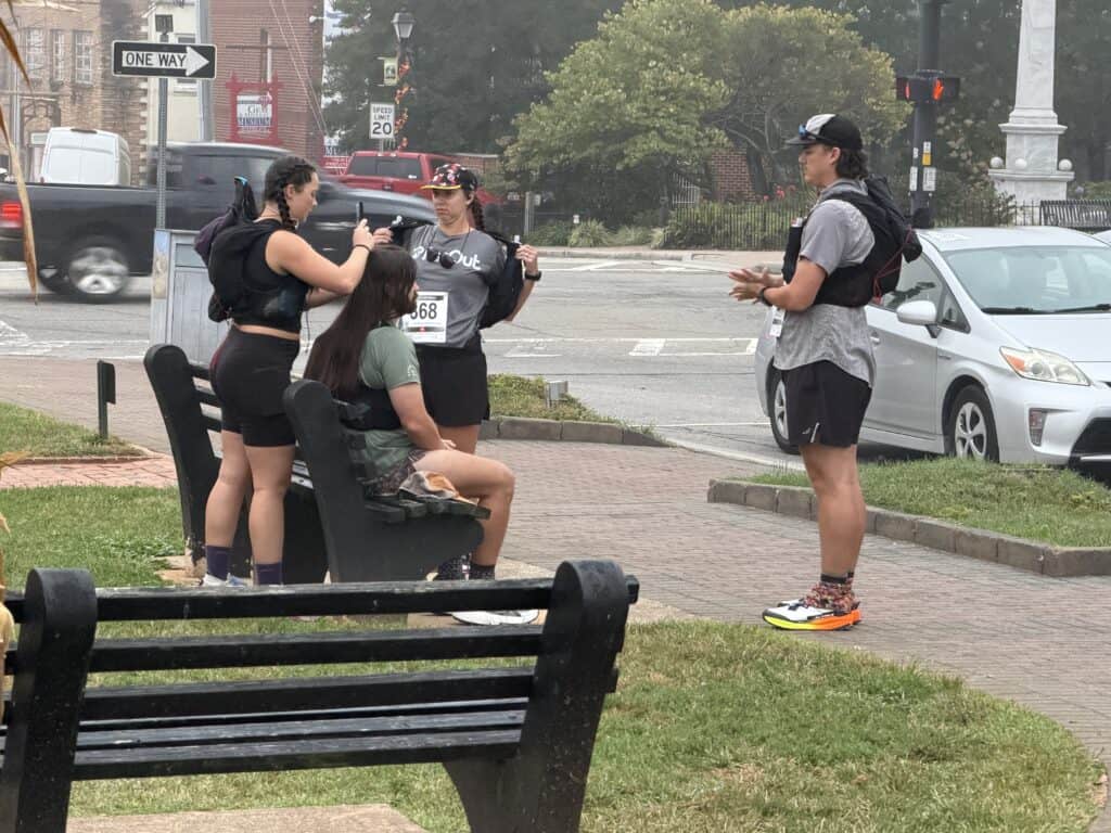Young women using smartphones at a park in Franklin during fall.
