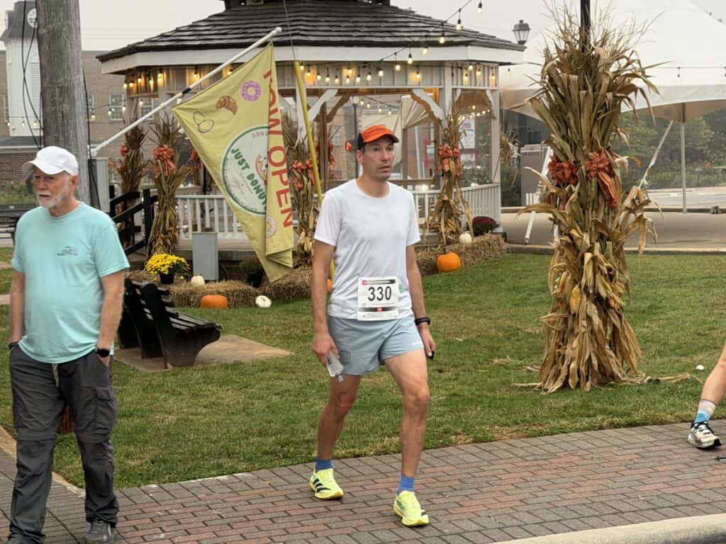 Man in athletic wear walking at fall festival in Franklin.
