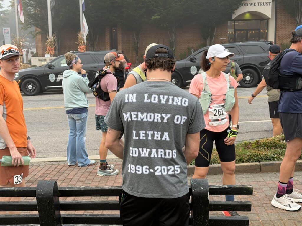 People participating in a fall family fun run in Franklin, with runners and spectators on the street.