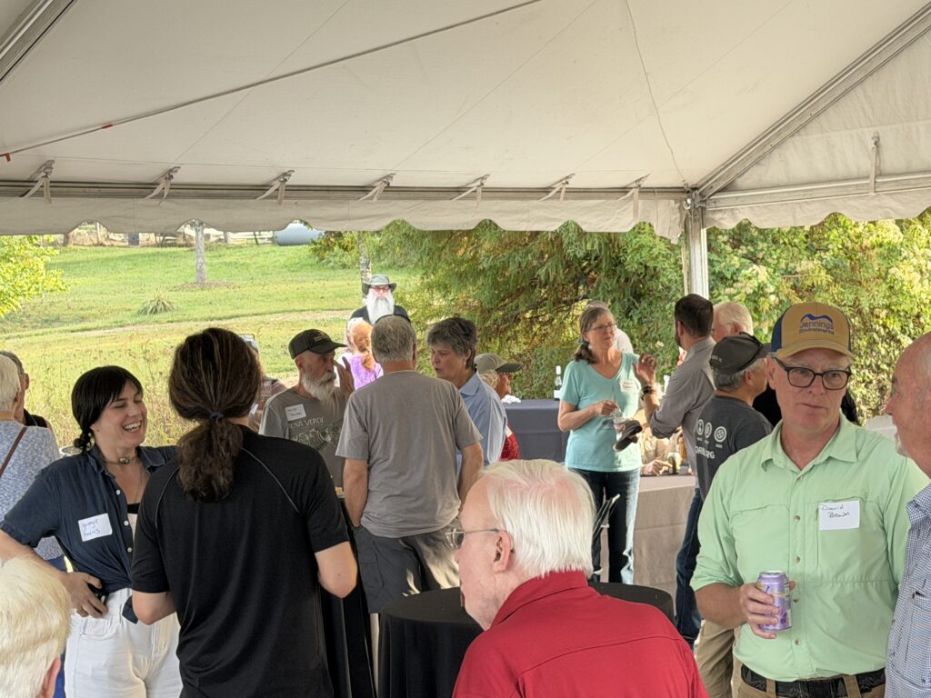 Family and friends enjoying outdoor fall event in Franklin under a large tent.