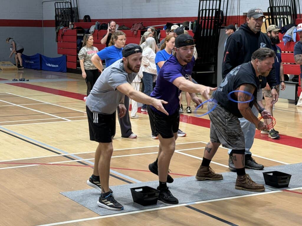 Group of people participating in team-building exercise indoors.