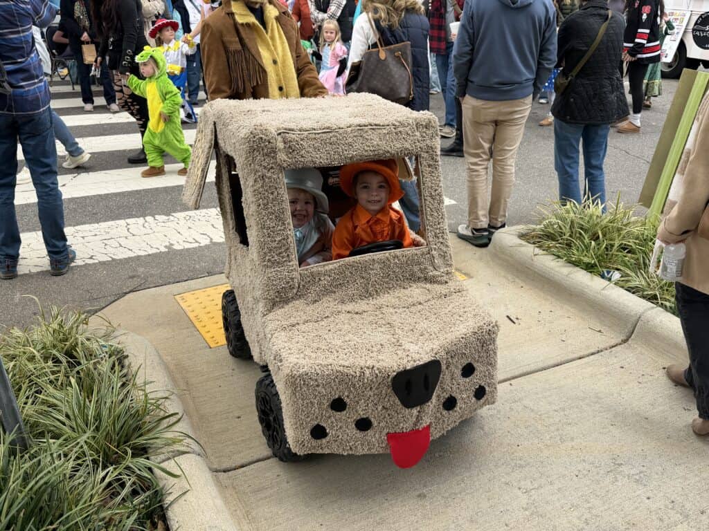 Kids riding a dog-themed cart during Franklin fall festival.
