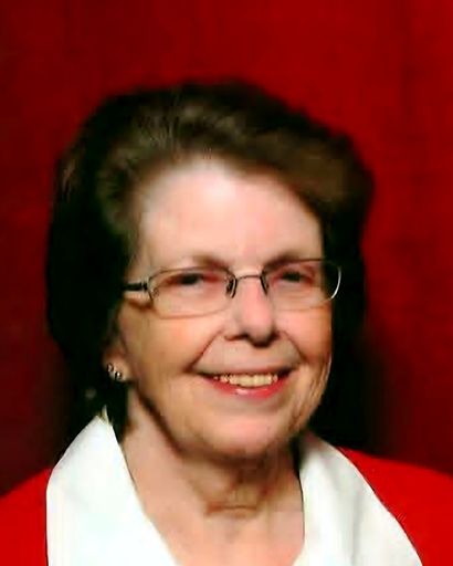 Elderly woman with glasses smiling, wearing a red and white outfit.